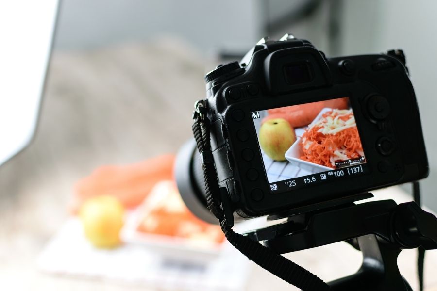 Professional camera capturing food photography lighting setup with natural light on colorful dish