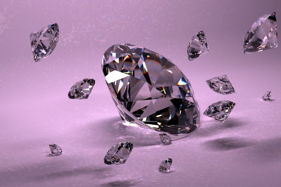 Lab grown diamonds of various sizes displayed on purple gradient background