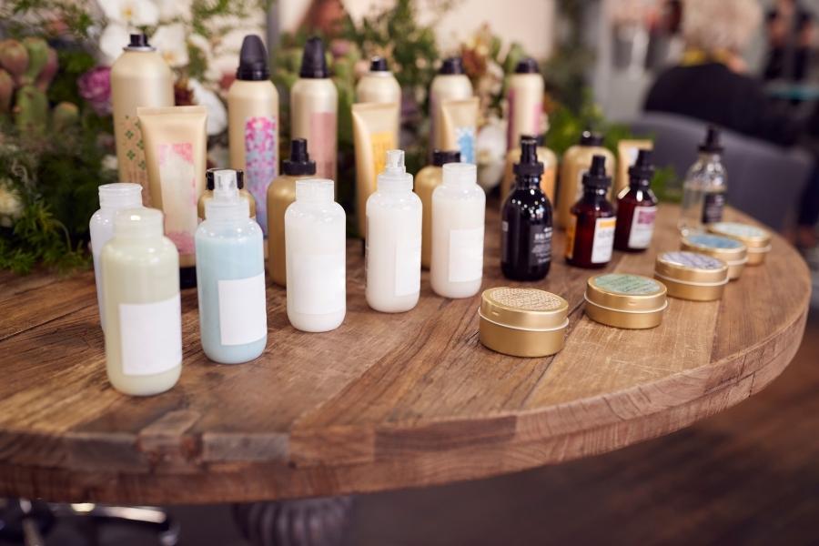 Collection of beauty products to save money on arranged on wooden table display