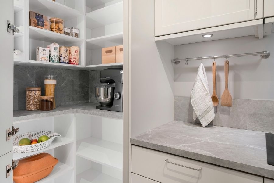 Modern kitchen organization system with white cabinets and organized pantry storage solutions