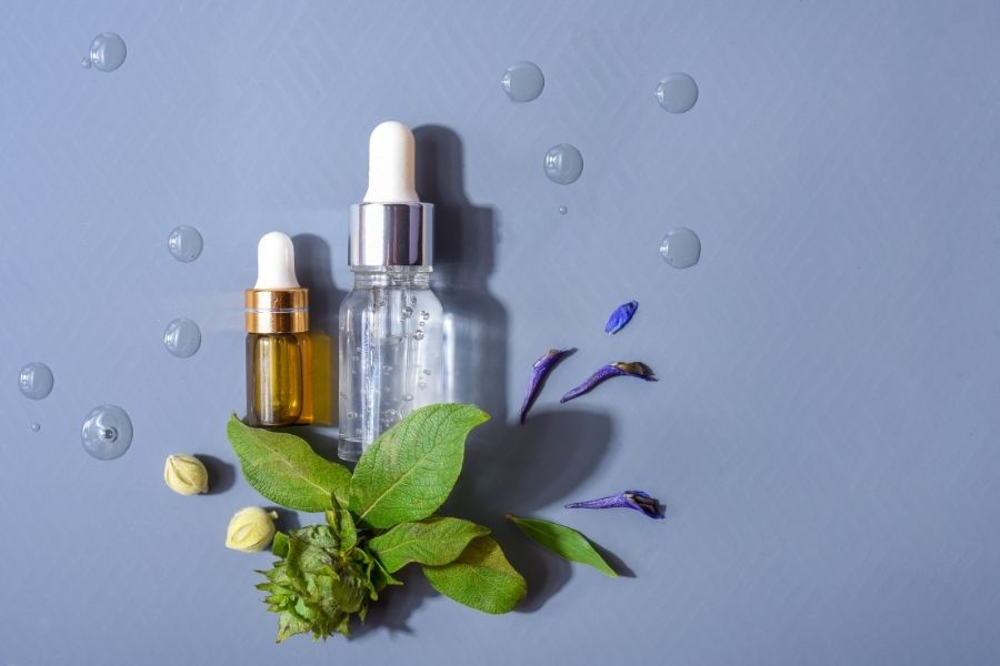 Natural skincare serums with flower petals comparing retinol vs bakuchiol benefits