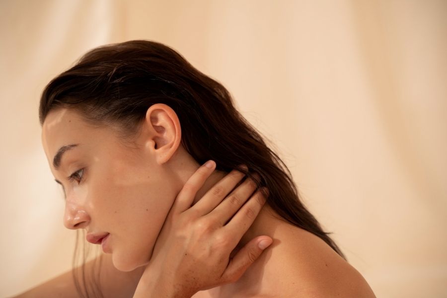Woman with smooth radiant complexion showcasing glass skin beauty trend