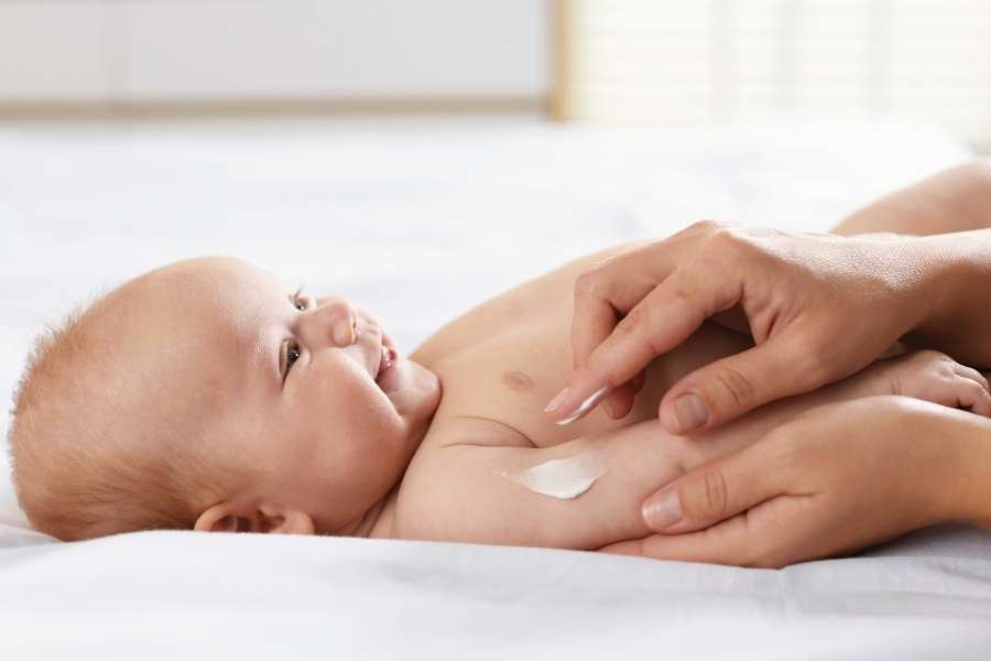 Baby receiving gentle skincare with lotion for Skin Conditions in Babies