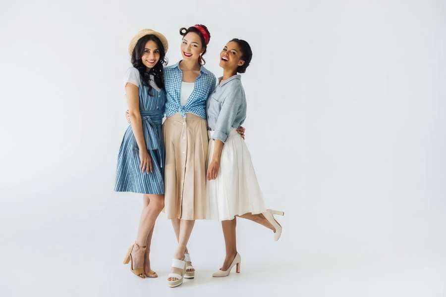 Three stylish women wearing chic outfits to Elevate Your Office look with a touch of modern sophistication.